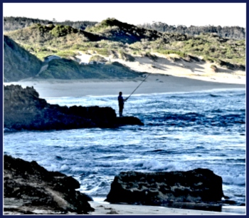 Lone fisher on the rocks at Swartvlei