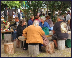 Folks enjoying sit-down breakfasts at the Farmers' Outdoor Market.