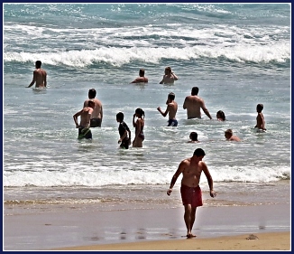 Bathers enjoying the waves on Myoli Beach Bathers enjoying the waves on Myoli Beach