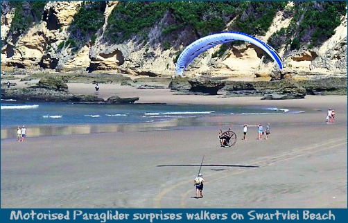 Motorised Paraglider flying low at the Swartvlei Beach