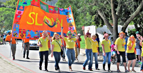 The Slow Festival Organising Team carrying the banner in the Sunday Street Parade.