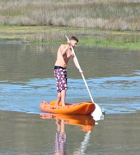 Stand up Paddling in a canoe on the Swartvlei Lagoon Stand up Paddling in a canoe on the Swartvlei Lagoon