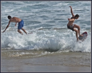 Two surfers practising in the shallows at Myoli Beach